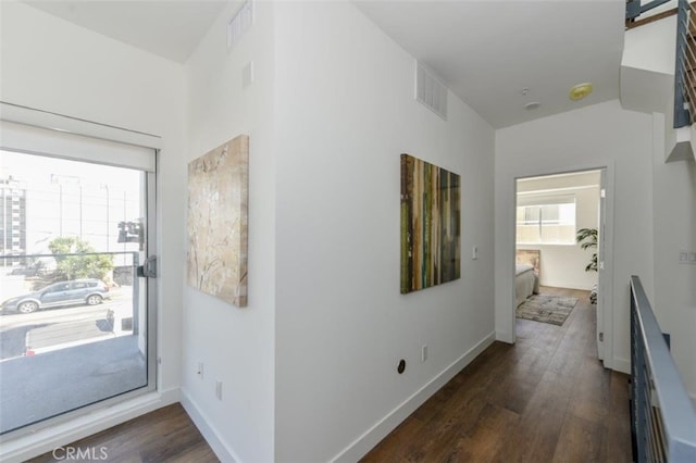 interior space with dark wood-type flooring and a wealth of natural light