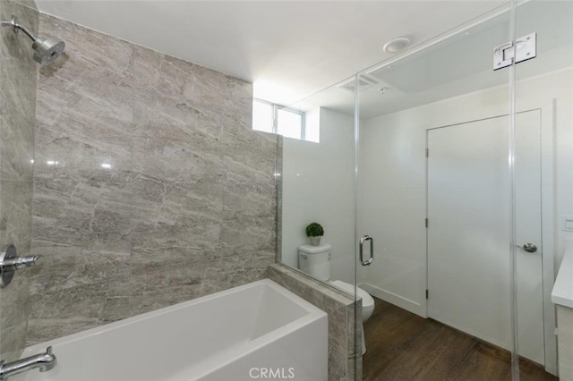 bathroom with toilet, separate shower and tub, and hardwood / wood-style floors