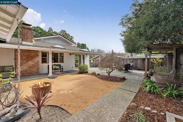 view of yard featuring a patio area and a fire pit