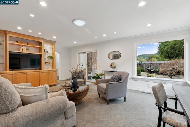 living room featuring ornamental molding and light carpet