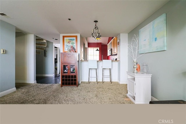 interior space with a notable chandelier and carpet floors