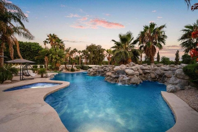 pool at dusk with a patio