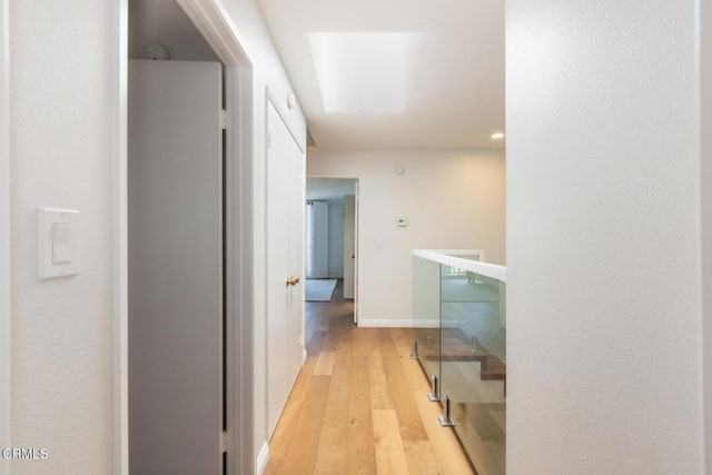 corridor with light hardwood / wood-style floors