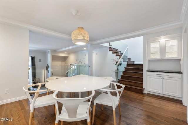 dining space with crown molding and dark hardwood / wood-style floors