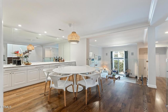 dining area with crown molding and wood-type flooring