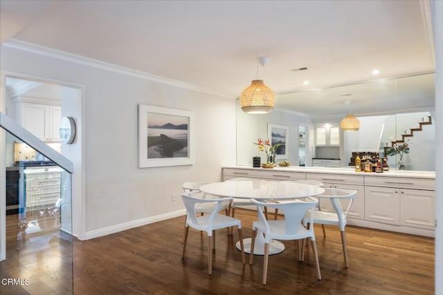 dining room with crown molding and wood-type flooring