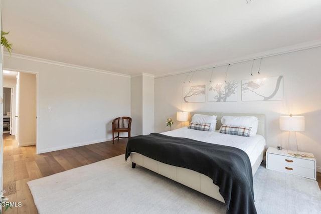 bedroom with crown molding and wood-type flooring