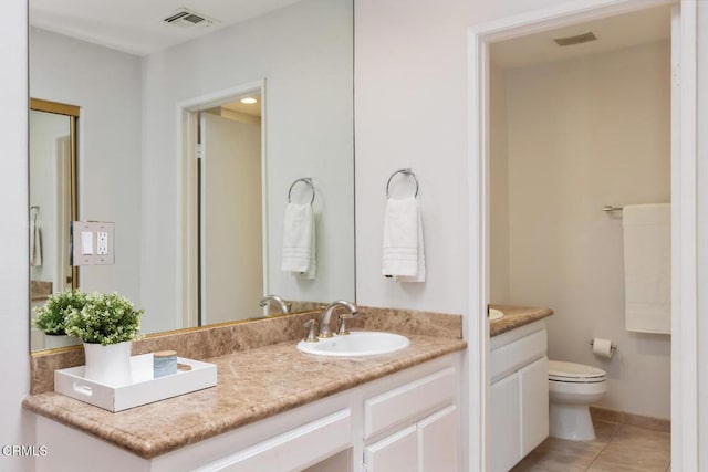 bathroom with vanity, tile patterned floors, and toilet