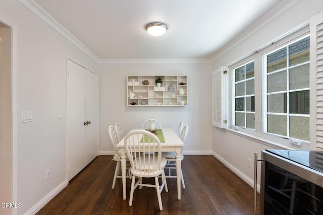 dining room with dark wood-type flooring, crown molding, and wine cooler