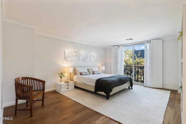 bedroom with wood-type flooring, access to outside, and crown molding