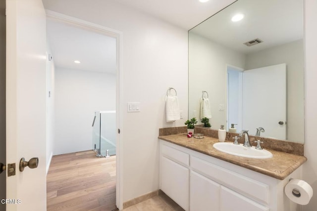 bathroom with vanity and hardwood / wood-style floors