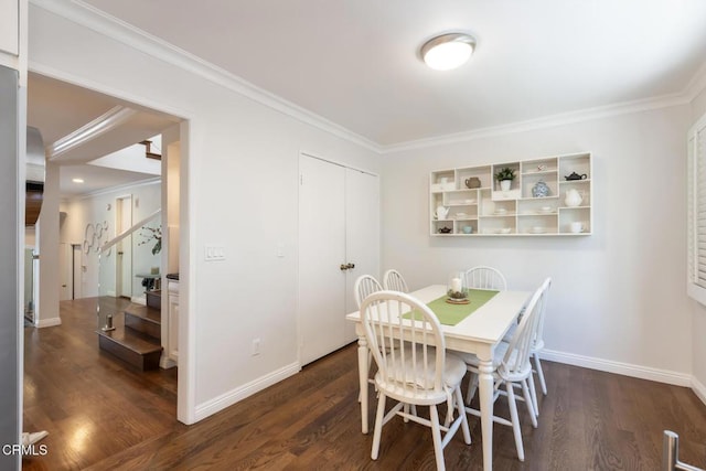 dining room with dark wood-type flooring and ornamental molding