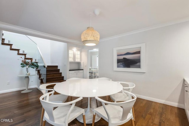 dining room with dark wood-type flooring and ornamental molding