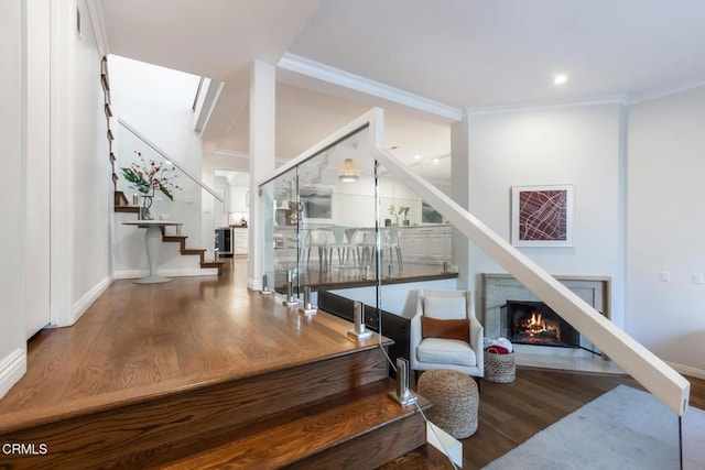 interior space with hardwood / wood-style floors and crown molding