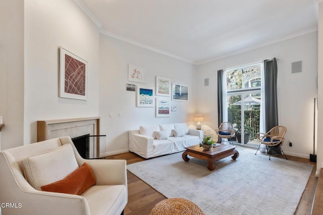 living room featuring hardwood / wood-style flooring and ornamental molding