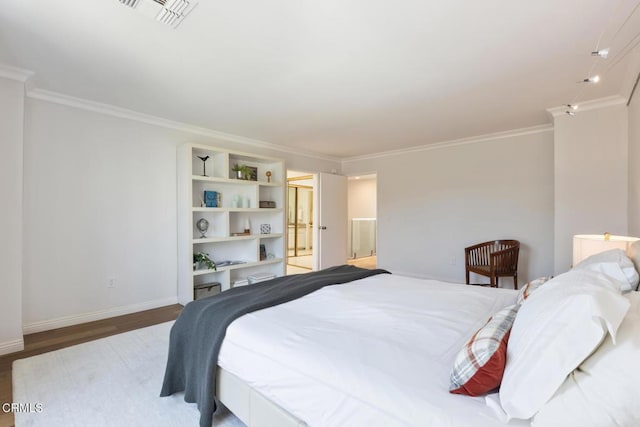 bedroom featuring wood-type flooring and ornamental molding