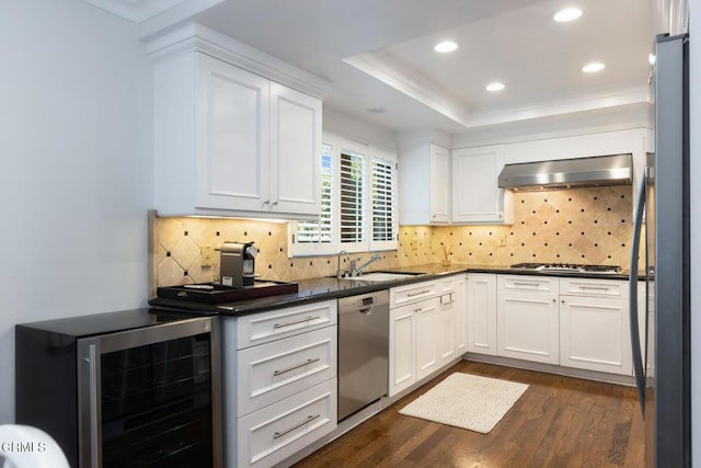 kitchen with wine cooler, white cabinetry, range hood, and appliances with stainless steel finishes