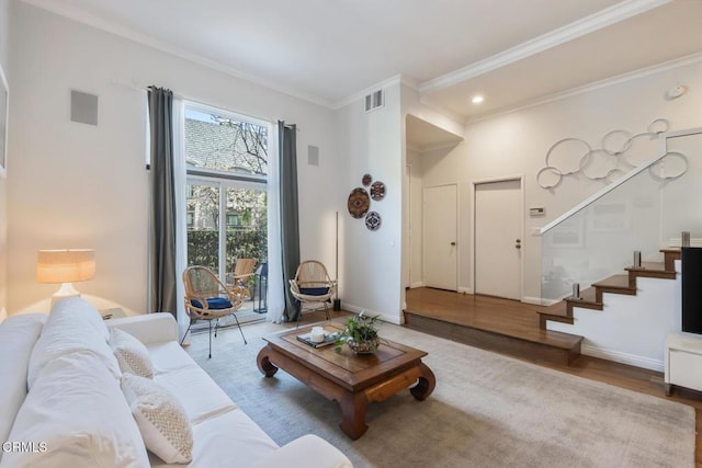 living room with wood-type flooring and ornamental molding