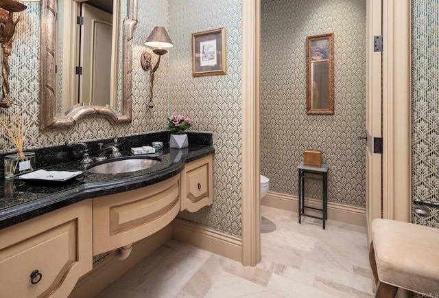 7756 St Andrews Rd, Rancho Santa Fe, CA 92067 - bathroom with toilet, vanity, baseboards, and wallpapered walls
