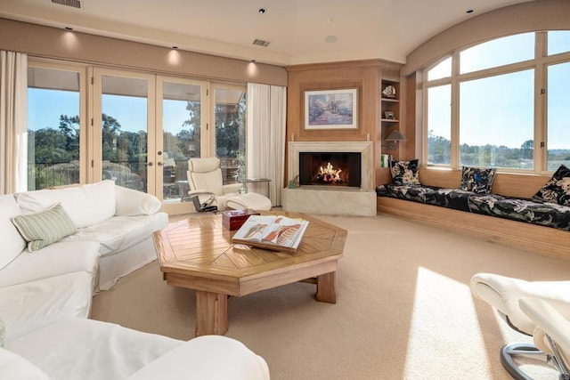 7756 St Andrews Rd, Rancho Santa Fe, CA 92067 - carpeted living room featuring french doors, built in features, a premium fireplace, and visible vents