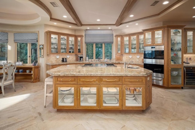 7756 St Andrews Rd, Rancho Santa Fe, CA 92067 - kitchen with a kitchen island with sink, visible vents, brown cabinets, and wine cooler