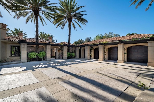7756 St Andrews Rd, Rancho Santa Fe, CA 92067 - mediterranean / spanish house featuring stucco siding, driveway, stone siding, a garage, and a tiled roof