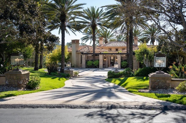 7756 St Andrews Rd, Rancho Santa Fe, CA 92067 - mediterranean / spanish-style home featuring a tiled roof, stucco siding, a front lawn, a chimney, and concrete driveway