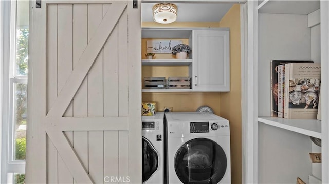 16532 Harbour Ln, Huntington Beach, CA 92649 - laundry area featuring a barn door, cabinet space, and washing machine and clothes dryer