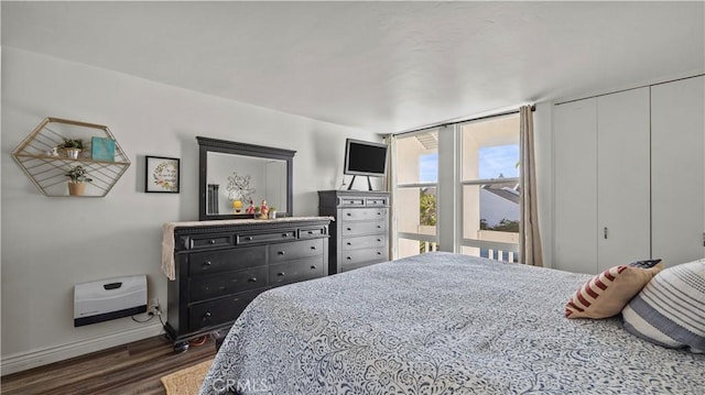 bedroom featuring baseboards and dark wood finished floors