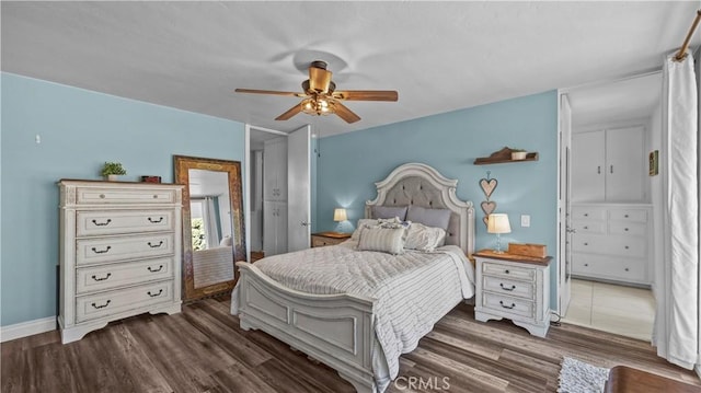 bedroom featuring baseboards, a ceiling fan, and wood finished floors