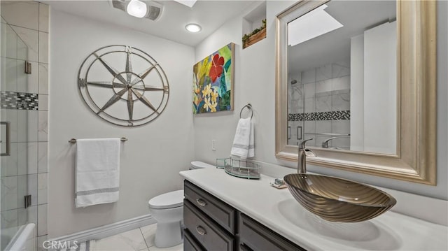 bathroom with toilet, baseboards, marble finish floor, and vanity