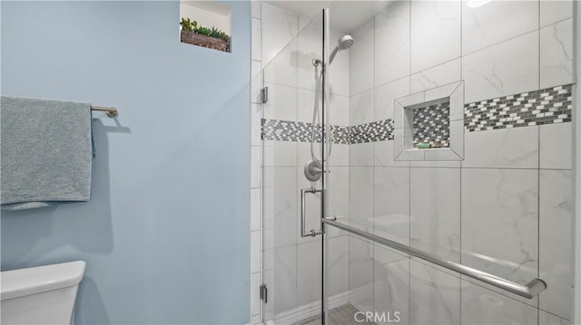 full bath with a stall shower and toilet