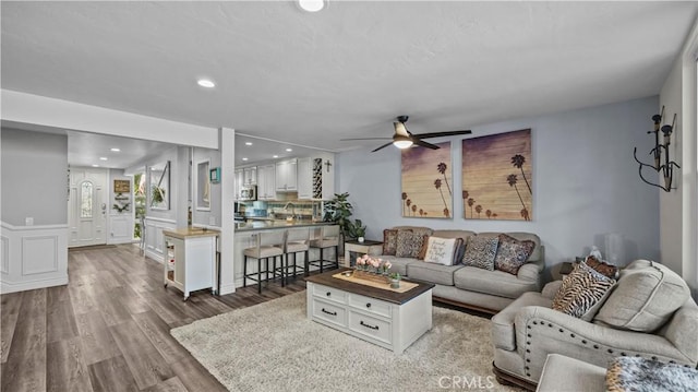 living area featuring recessed lighting, a ceiling fan, and wood finished floors