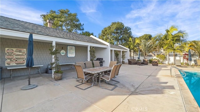 view of patio featuring a fenced in pool and outdoor dining area