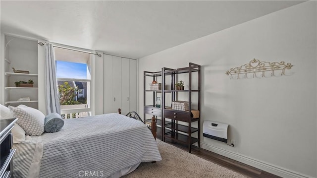 bedroom with baseboards and wood finished floors