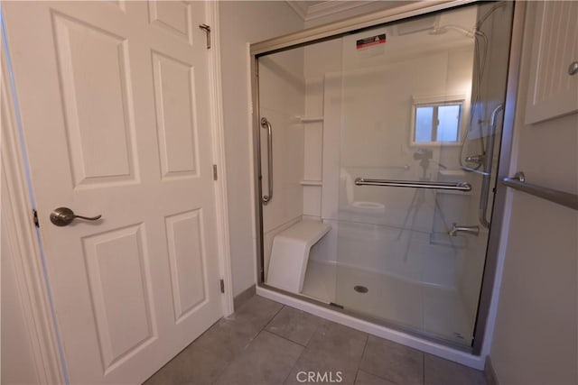 bathroom with tile patterned flooring and an enclosed shower