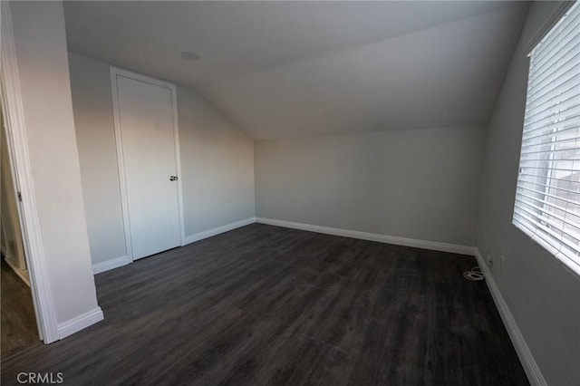 bonus room featuring dark hardwood / wood-style flooring and vaulted ceiling