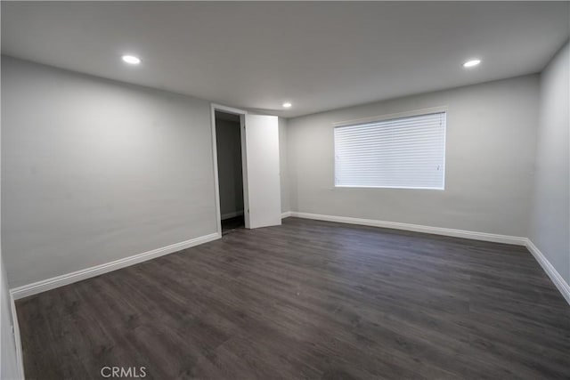 spare room with dark hardwood / wood-style flooring