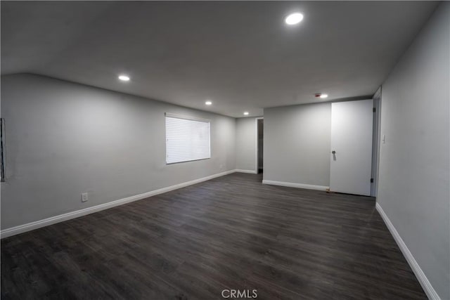 unfurnished room with recessed lighting, dark wood-style flooring, and baseboards