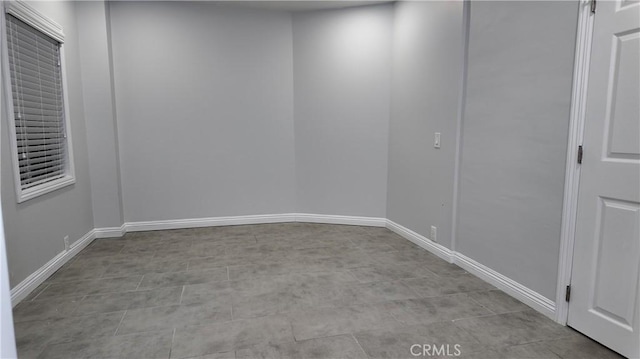 empty room featuring baseboards