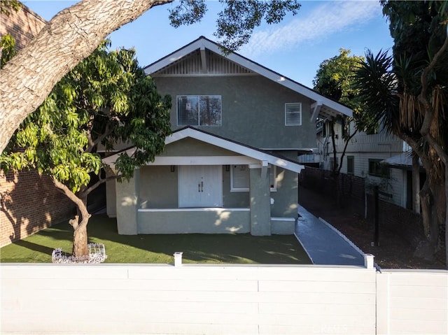 view of front of home featuring fence and stucco siding