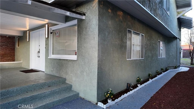 view of side of home with stucco siding