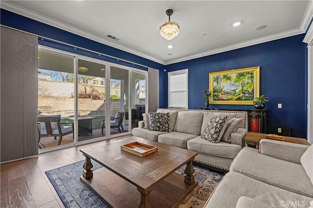 living room with hardwood / wood-style flooring and crown molding