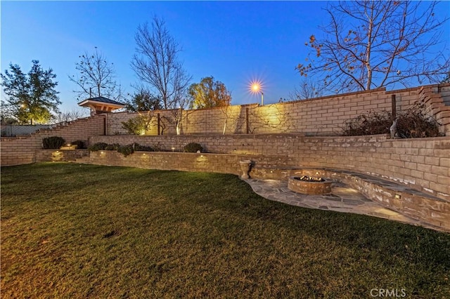 yard at dusk with a fire pit