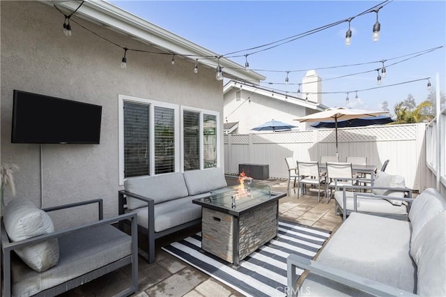 view of patio featuring an outdoor living space with a fire pit