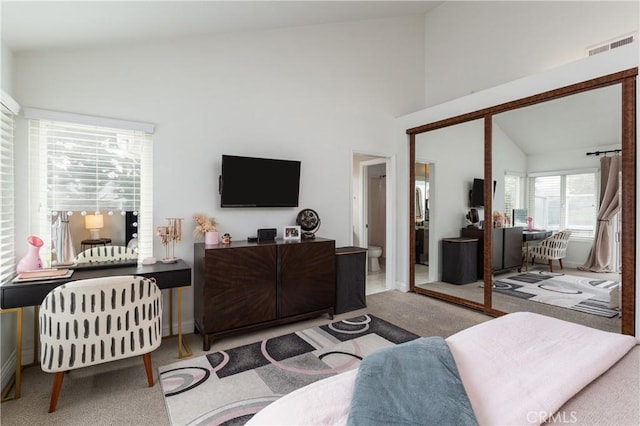 living room with light carpet and high vaulted ceiling