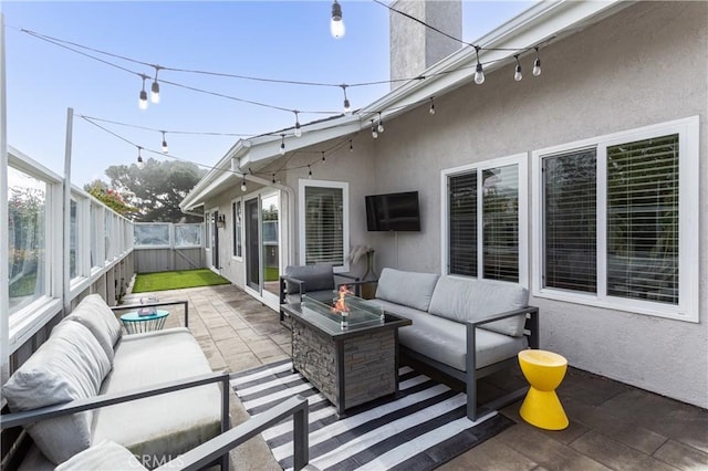 view of patio / terrace with an outdoor living space with a fire pit