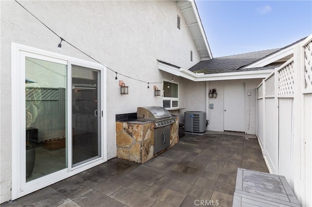 view of patio with area for grilling and central air condition unit