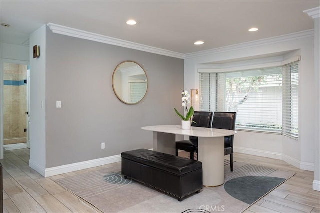 dining area with crown molding and light hardwood / wood-style floors