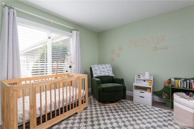 carpeted bedroom featuring a crib